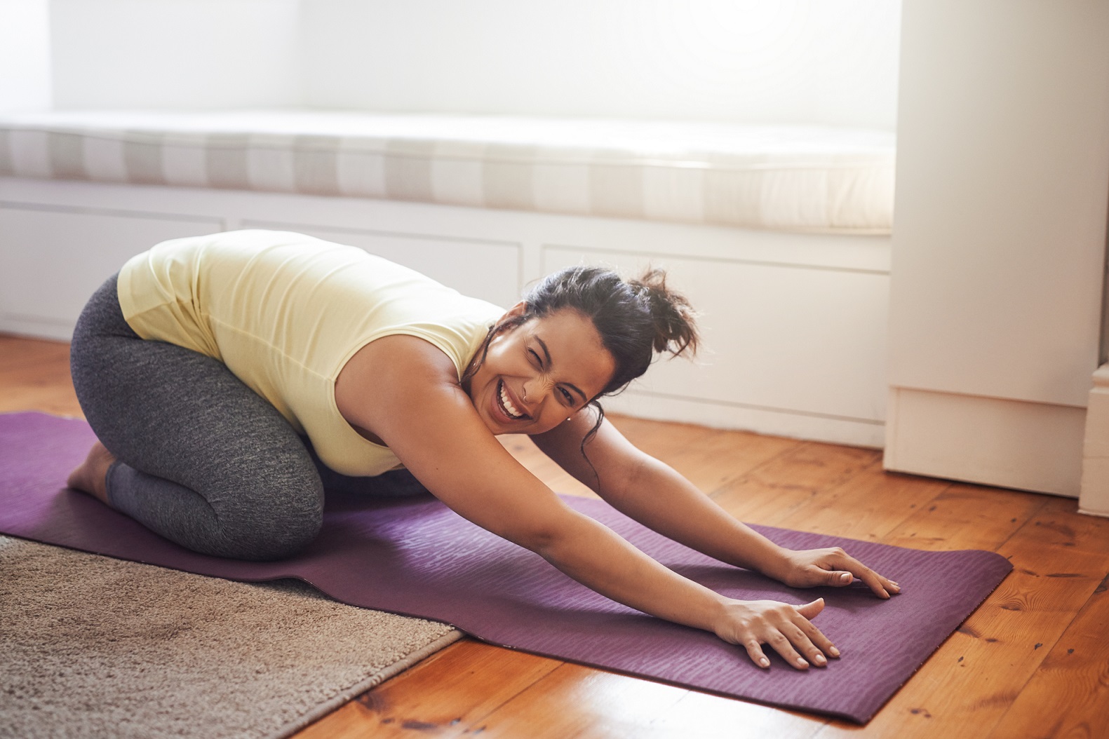 Woman happy while doing yoga